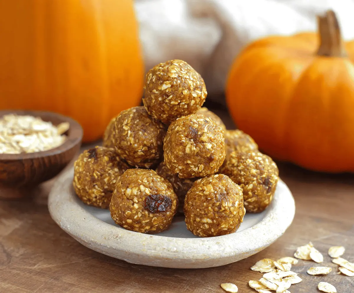 Healthy Pumpkin Oat Protein Balls on a white plate, featuring oats, pumpkin puree, and protein powder for a nutritious snack